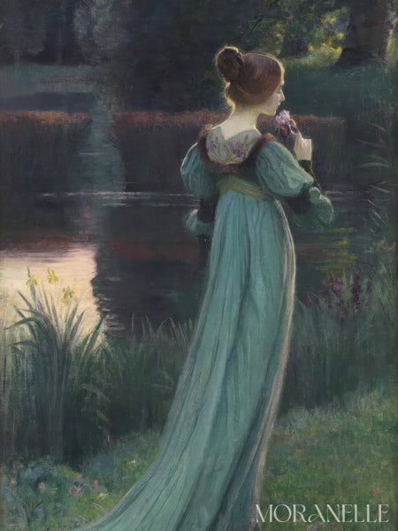 Woman in a long, light teal dress standing by a pond with a flower in her hand, surrounded by a pond.