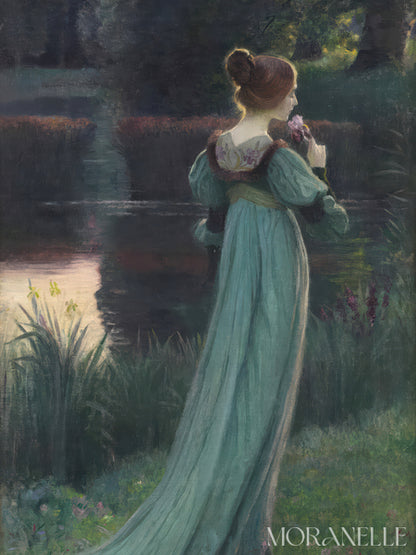 Woman in a long, light teal dress standing by a pond with a flower in her hand, surrounded by a pond.