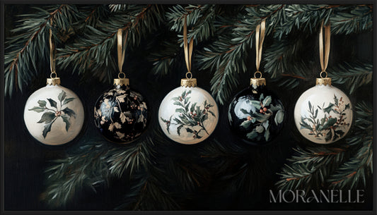 Antique-style Christmas ornaments with golden ribbons hanging from a pine branch.